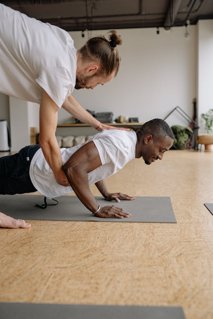 Man in White T-shirt and Black Shorts Doing Yoga